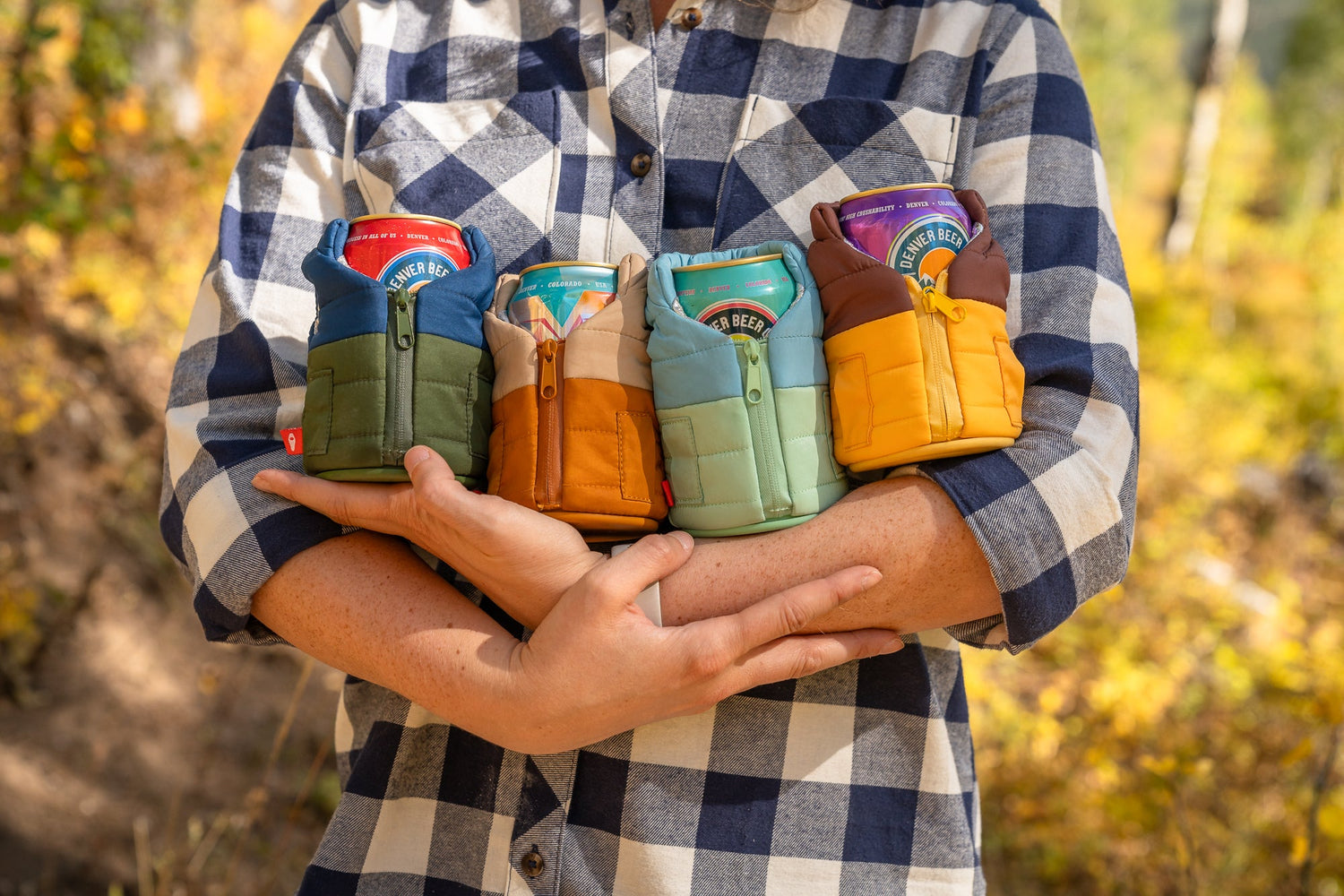 Man Holding Four Drinks in Funny Koozies-Type Can Sleeves