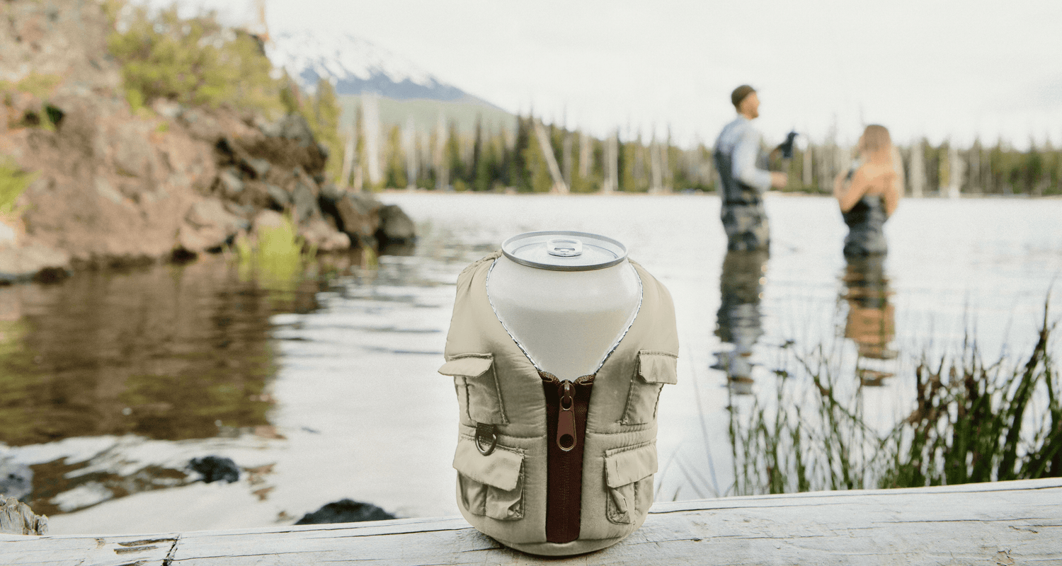 The Adventurer Koozie in Classic Tan on a lake