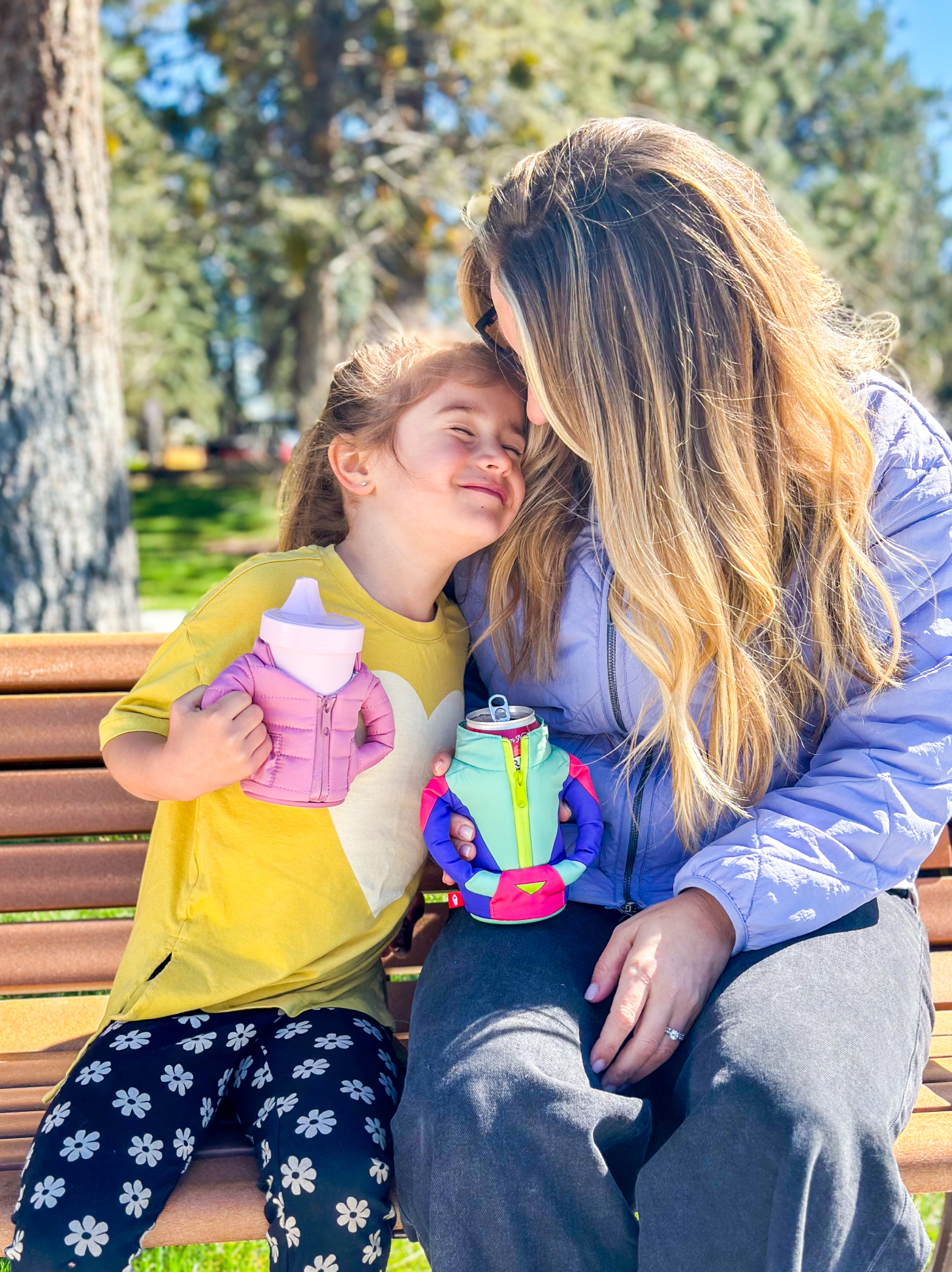 Mother and Daughter with Puffins in hands, keeping their drinks cold and their hands warm.