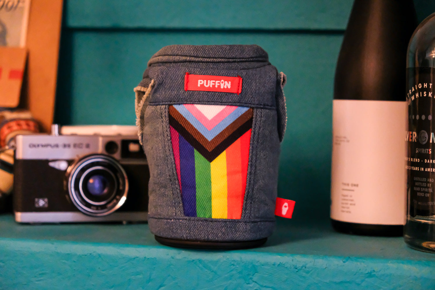 The Pride Vest - Puffin Drinkwear drink sleeves - with camera and wine on a bench